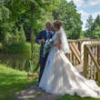 Bride with groom wearing a lace and tulle ballgown wedding dress