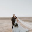 Bride And Groom Together. Bride Wearing Simple Ball Gown Wedding Dress With An Elegant Overskirt Called Kyrie By Maggie Sottero
