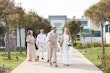 Bride wearing Davis Leigh wedding dress by Sottero and Midgley walking with her husband