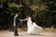 Bride with groom wearing satin sheath wedding dress.
