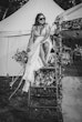 Bride wearing Lorraine by Rebecca Ingram sitting on a ladder