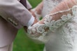 Bride wearing Nikki by Maggie Sottero holding hands with her husband