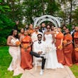 Bride Wearing Simple Fit and Flare Wedding Dress Called Anniston Lane With Bridal Party In Orange And Cream Outfits