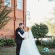 Bride Wearing Lace Long-Sleeve Wedding Gown Called Raphael By Maggie Sottero With Groom