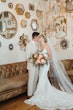 Bride wearing Albany wedding dress by Maggie Sottero kissing her husband