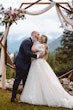 Bride Wearing Lace Aline Wedding Dress Called Harlem By Maggie Sottero Kissing Groom At The Altar