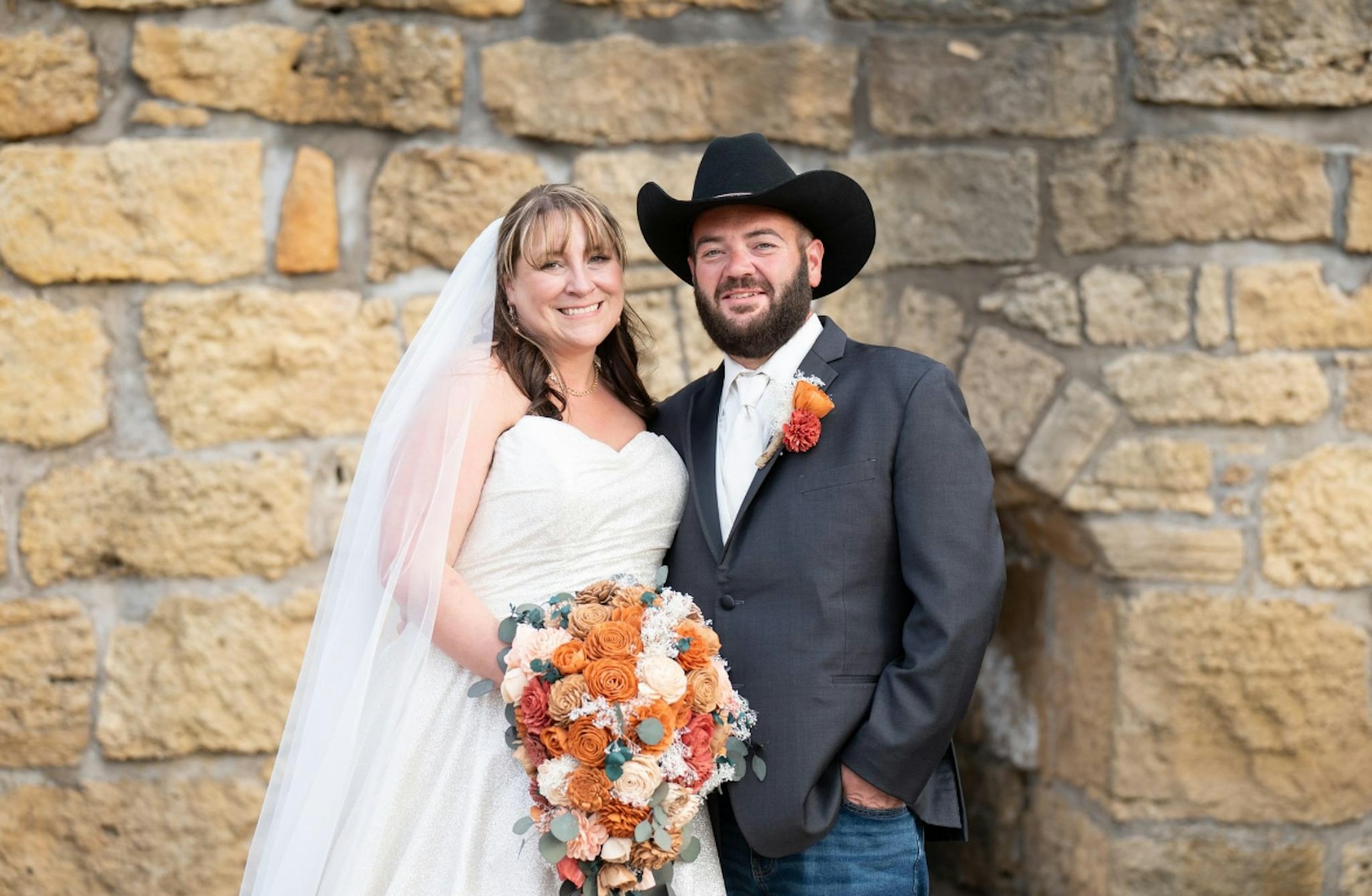 Bride Wearing Sparkly Aline Wedding Dress Called Anniston By Maggie Sottero With Groom In A Cowboy Hat