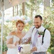 Bride Wearing Chiffon A-Line Wedding Dress Called Heather By Rebecca Ingram Cutting The Cake With Groom