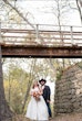 Bride Wearing Sparkly Aline Wedding Dress Called Anniston By Maggie Sottero With Groom Standing Under A Bridge