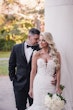 Bride Wearing Lace Mermaid Wedding Dress Called Alistaire By Maggie Sottero With Groom Holding A White Rose Bouquet