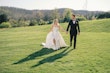 Bride wearing Selena by Maggie Sottero walking with her husband