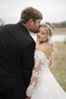 Bride In Off The Shoulder Lace Wedding Dress Called Tiffany By Maggie Sottero With Groom