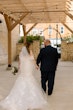 Bride wearing Hattie by Rebecca Ingram walking with her husband