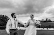 Bride Wearing Boho Wedding Dress Called Lorraine Dawn By Rebecca Ingram Holding Hands with Groom