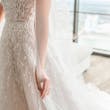 Bride wearing Marvine wedding gown by Sottero and Midgley