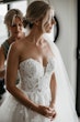 Bride wearing Indiana by Maggie Sottero being zipped up