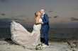 Groom Kissing Bride in Lovely Plus Size Fit-and-Flare Tulle Wedding Dress with Delicate Lace Motifs Accented with Beading Called Glorietta Lynette by Maggie Sottero