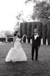 Bride wearing Hattie Lynette wedding dress by Rebecca Ingram holding hands with her husband