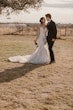 Bride wearing Bridget by Maggie Sottero drinking with her husband