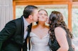 Bride Wearing Off-The-Shoulder A-Line Wedding Dress Called Coral By Rebecca Ingram Getting Kissed By Family