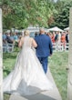 Bride in whimsical lace train wedding dress called meryl by maggie sottero with groom on aisle