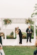 Bride wearing Clover by Rebecca Ingram kissing her husband during their ceremony