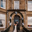 Bride Wearing Art Deco Wedding Dress Called Luella By Sottero And Midgley With Groom On A Porch