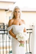 Bride Wearing Pearl Sparkly Bridal Gown Called Drew By Maggie Sottero Holding White Rose Bouquet