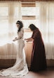 Bride Wearing Lacey Sheath Long Sleeve Wedding Dress Called Francesca By Maggie Sottero Getting Ready Doing Buttons