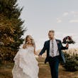 Bride Wearing Square Neck Long Sleeve Floral Wedding Dress Called Sawyer By Sottero And Midgley Walking With Groom Holding Her Bouquet
