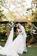 Bride wearing Lettie by Rebecca Ingram kissing her husband