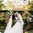 Bride wearing Lettie by Rebecca Ingram kissing her husband