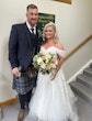 Bride wearing Rousseau wedding dress by Maggie Sottero next to her groom