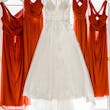 Florence wedding dress by Maggie Sottero hanging up next to bridesmaid dresses