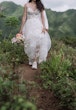 Bride wearing Winter wedding dress by Maggie Sottero hikes in tennis shoes