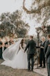 Bride And Groom At The Altar. Bride Wearing Romantic Long Sleeve Boho Ball Gown Called Mallory Dawn By Maggie Sottero