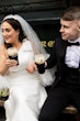 Bride wearing Saratoga by Maggie Sottero drinking with her husband