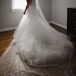 Bride wearing Holden wedding dress by Sottero and Midgley with veil