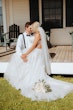 Groom With Bride Wearing A-Line Lace Wedding Dress Marisol By Rebecca Ingram