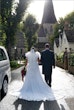 Bride Wearing Chiffon Lace Wedding Dress Called June By Maggie Sottero Walking With Groom Outside