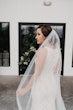 Bridal Portrait Wearing High Neck Halter Wedding Dress With Lace Motifs Called Kevyn By Sottero And Midgley 