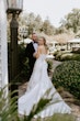 Groom Smiling At Bride In A White Strapless Wedding Dress Named Mitchell By Maggie Sottero