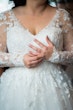 Bride Wearing Long Sleeve Ball Gown Wedding Dress With A Tiered Organza Skirt Tessa By Rebecca Ingram