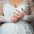 Bride Wearing Long Sleeve Ball Gown Wedding Dress With A Tiered Organza Skirt Tessa By Rebecca Ingram