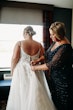 Bride getting Pia wedding dress by Maggie Sottero zipped up