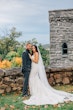 Groom Posing With Real Bride Wearing A Vintage White Wedding Gown Named Veronique by Maggie Sottero