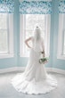 Bride Standing by Window Wearing a Classic Lace Wedding Dress Called Brenda by Rebecca Ingram