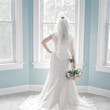 Bride Standing by Window Wearing a Classic Lace Wedding Dress Called Brenda by Rebecca Ingram