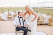 Bride Wearing Lace Mermaid Wedding Dress Called Bronson By Sottero And Midgley Looking At Groom Sitting Down