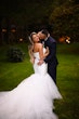 Bride wearing Holden wedding dress by Sottero and Midgley being kissed by her husband